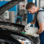 A professional from LSA Oils is refilling premium motor oil in a car engine in High Wycombe, WA